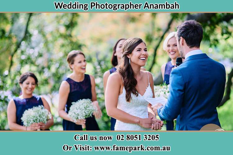 The Groom is reading a note for her happy Bride as she looks at him Anambah