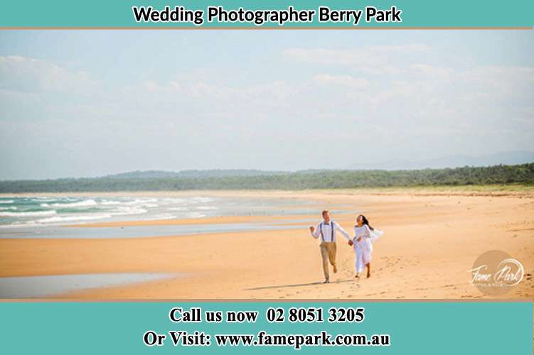 The Groom and the Bride running down the beach Berry Park