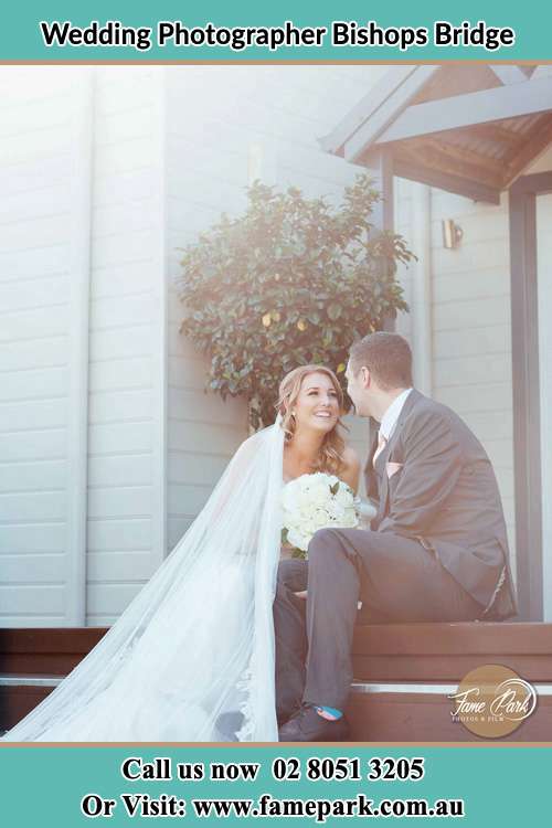 Photo of the Bride and the Groom sitting outside the house Bishops Bridge NSW 2326