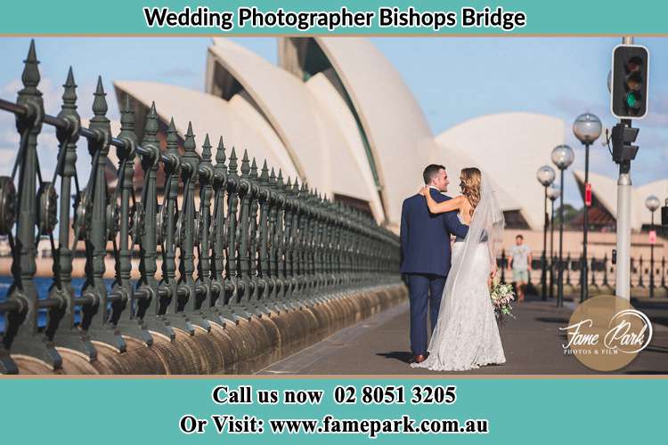 Sweet photo of the Groom and the Bride walking on the street Bishops Bridge NSW 2326