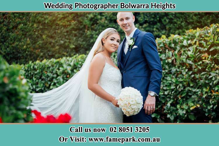 The Groom and the Bride in the garden poses for the camera Bolwarra Heights