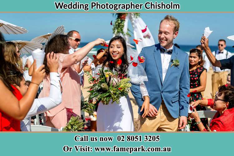 Photo of the Bride and the Groom showering flower petals by their visitors Chisholm NSW 2322