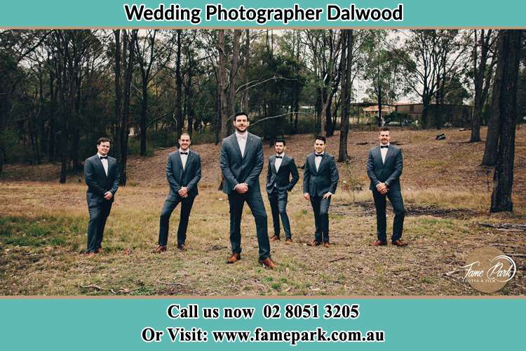 The Groom with his groomsmen pose in front of the camera Dalwood