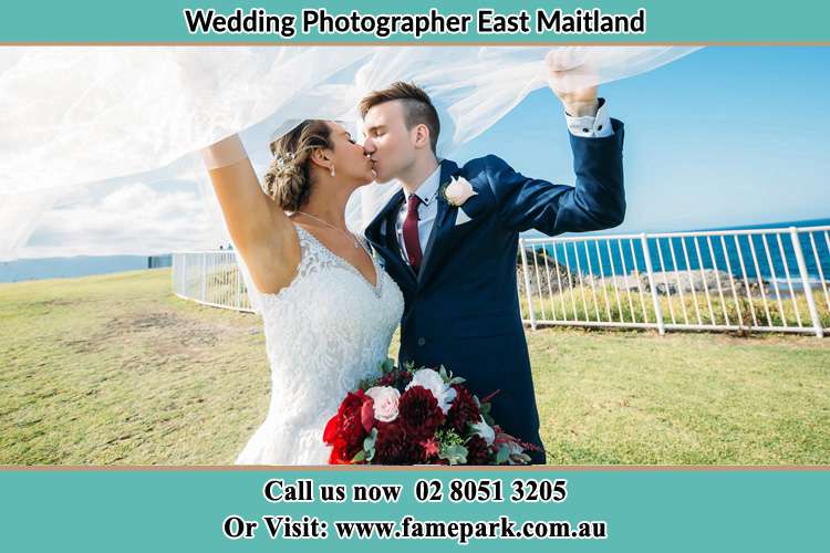 The Groom and the Bride Kissing near the shore East Maitland