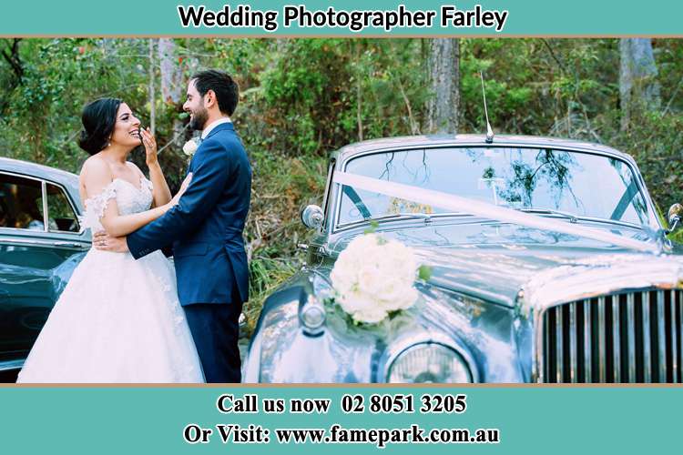 Photo of the Groom and the Bride standing outside the car Farley NSW 2320