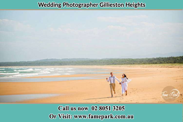 Photo of the Groom and the Bride walking on the sea shore Gillieston Heights NSW 2321