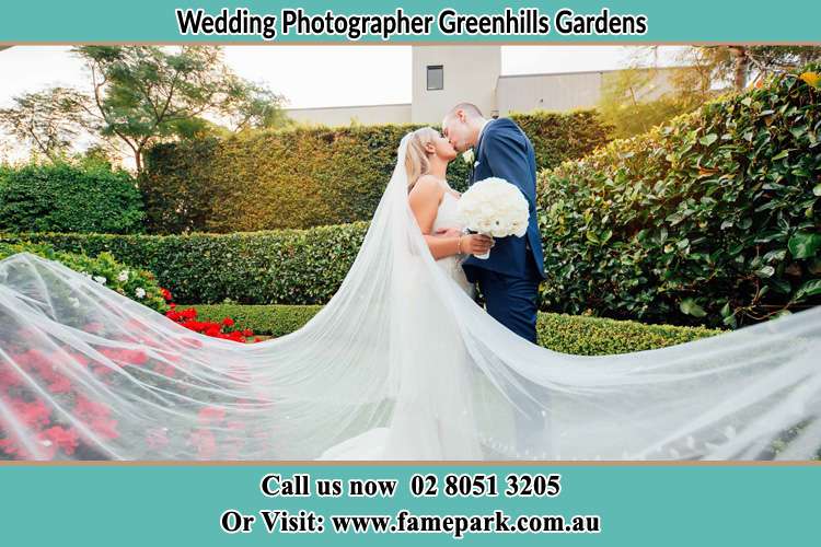 Photo of the newly weds kissing in the garden Greenhills Gardens