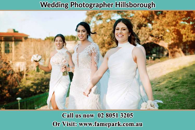 The Bride and her bridesmaids smiles as they walk Hillsborough