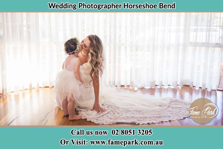 Photo of the Bride kiss by her flower girl Horseshoe Bend NSW 2320