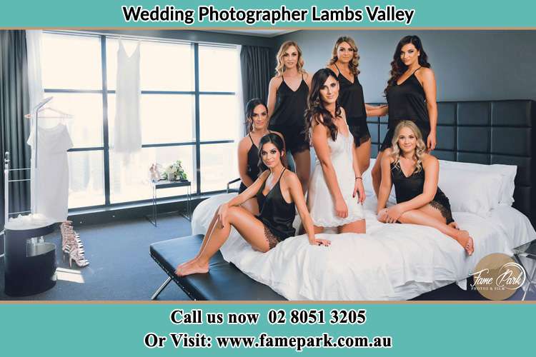 Photo of the Bride with her bridesmaids wearing sexy lingerie on the bed Lambs Valley NSW 2335