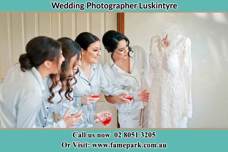 Photo of the Bride and her bridesmaids checking her wedding gown Luskintyre NSW 2321