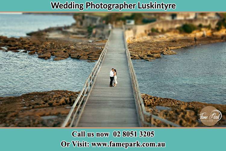 Photo of the groom and the Bride kissing on the bridge Luskintyre