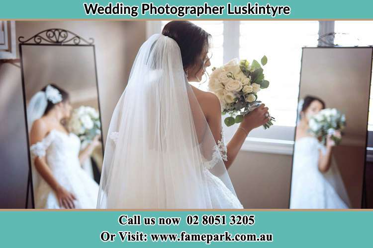 Behind photo of the Bride holding flower on the front of the mirrors Luskintyre NSW 2321