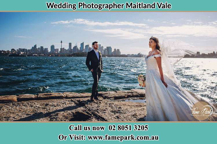 The Groom and the Bride poses for the camera near the shore Maitland Vale