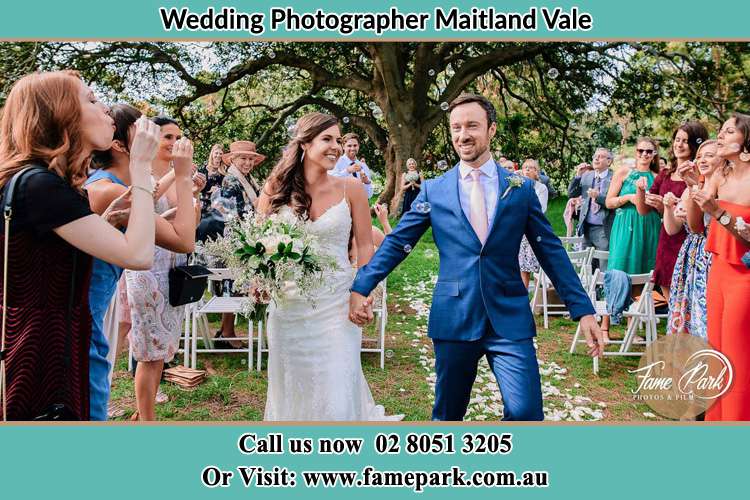 Photo of the Bride and the Groom showering bubbles by their visitors Maitland Vale NSW 2320