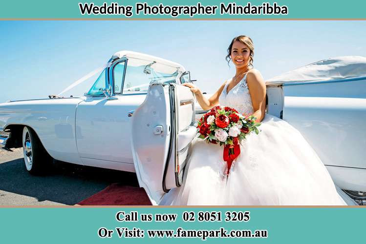 The Bride holding bouquet of flowers besides her bridal car Mindaribba