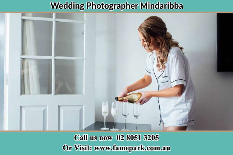 Photo of the Bride pouring wine to the glasses Mindaribba NSW 2320