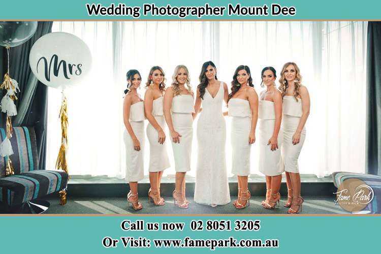 Photo of the Bride together with her bridesmaids posing on the camera Mount Dee NSW 2320