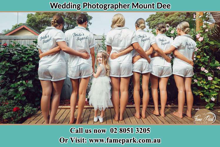 Behind photo of the Bride and her bridesmaids with the flower girl looking back to the camera Mount Dee NSW 2320