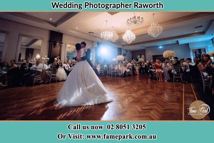 Photo of the Bride and the Groom embrace each other on the dance floor Raworth NSW 2321