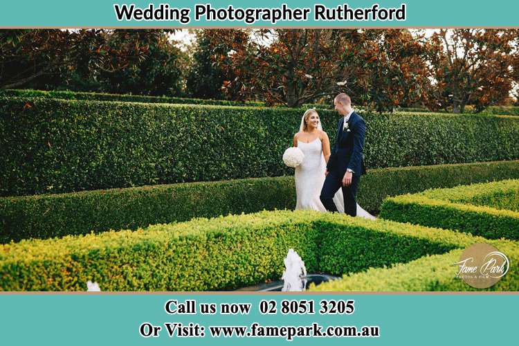 Photo of the Bride and Groom waiking at the garden Rutherford