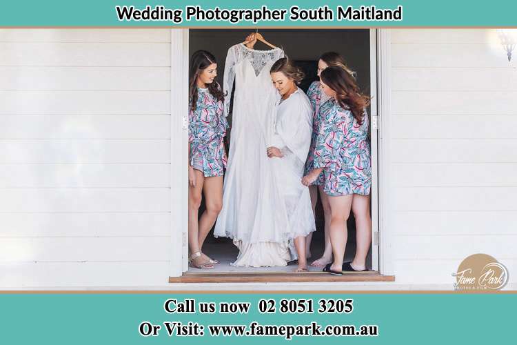 The girls with the Bride holding her bridal gown South Maitland