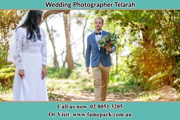 Photo of the Groom giving flower to the Bride Telarah NSW 2320