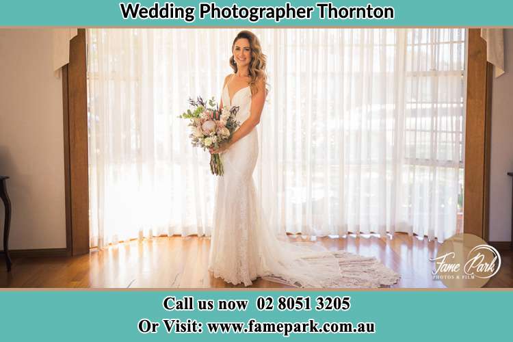 The Bride striking a pose on the camera holding a bouquet of flowers Thornton NSW 2322