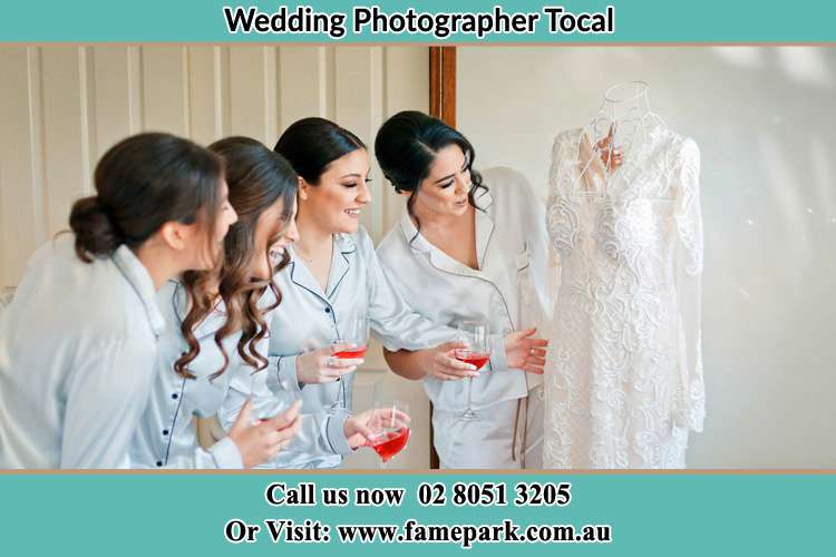 Photo of the Bride and the Bride's Maid looking at the gown Tocal