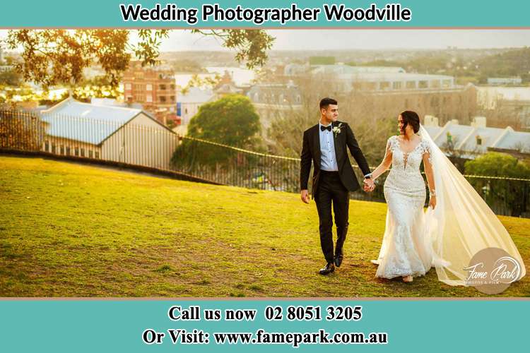 Photo of the Groom and the Bride holding hands while walking on the garden Woodville NSW 2321